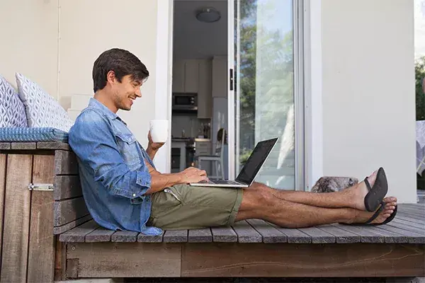 man on porch drinking coffee